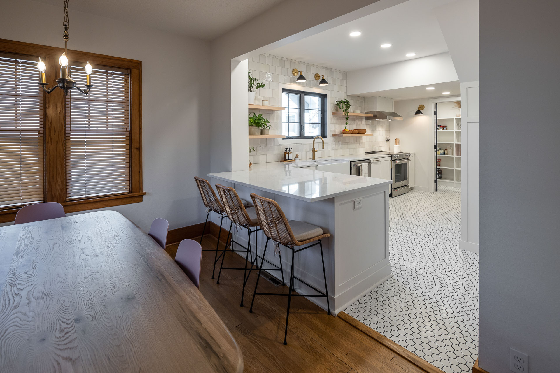 kitchen with new interior design features including lights, stools and decor.